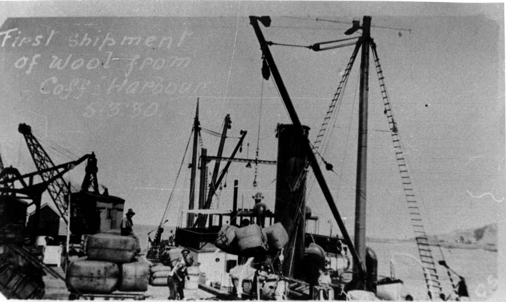 Cranes on Coffs Harbour Jetty load the first shipment of wool bales from the New England region, 5 March 1930