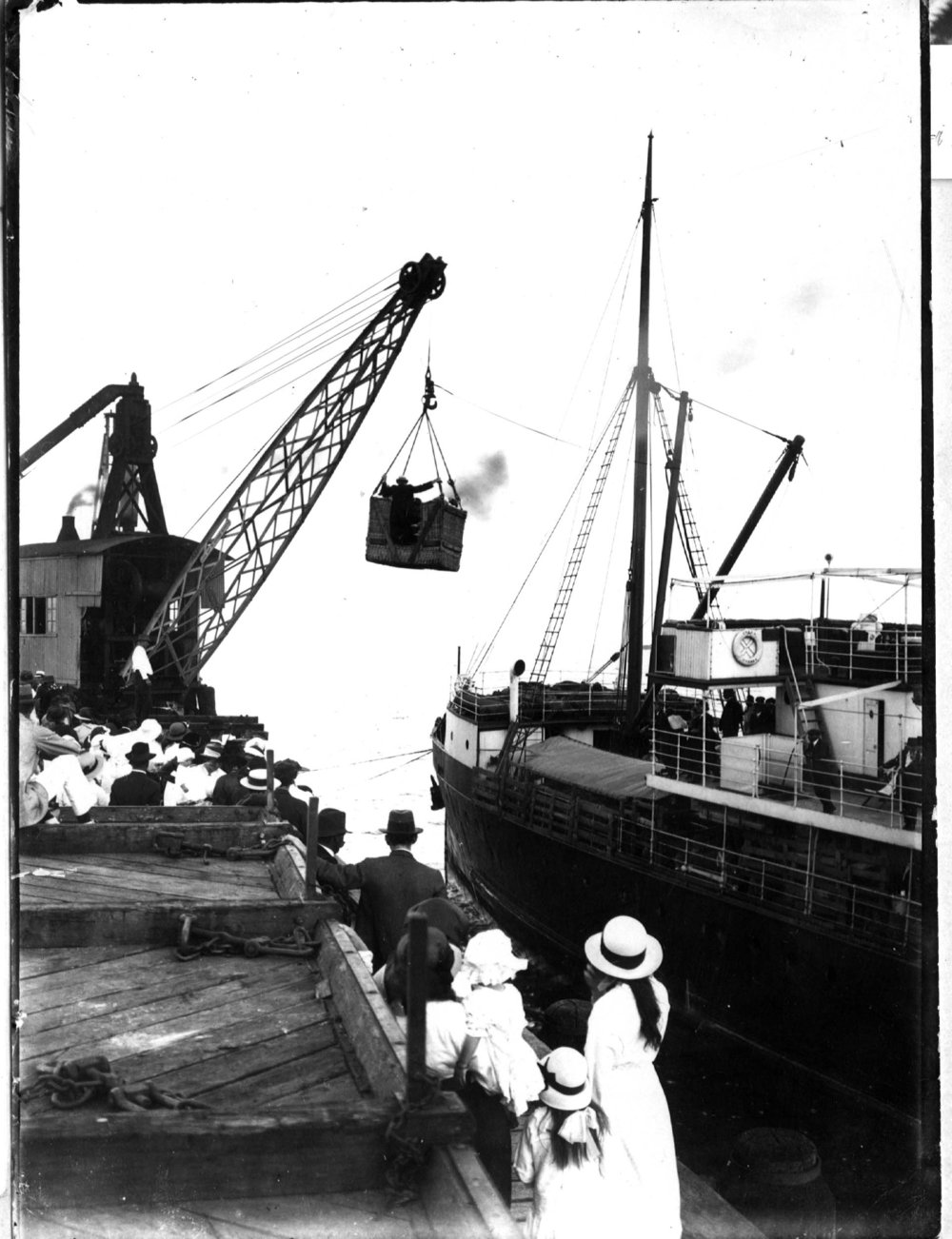 Passengers await transfer by crane and basket onto passenger ship S. S. Orara at the Coffs Harbour Jetty, early 1900s