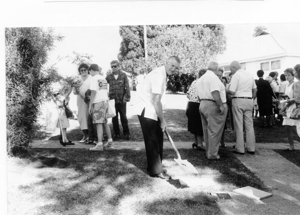 Parish Priest Father Tony Casey placing the commemoration stone for the 75th Anniversary of St Augustine's School, April 1988 