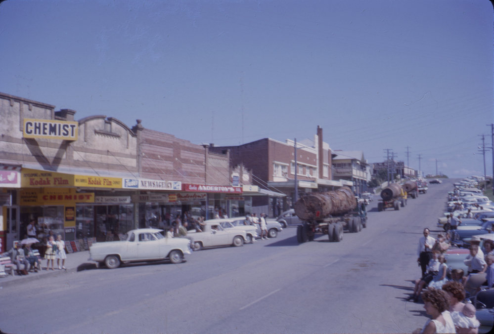 Procession of timber logs, Coffs Jetty, 1964