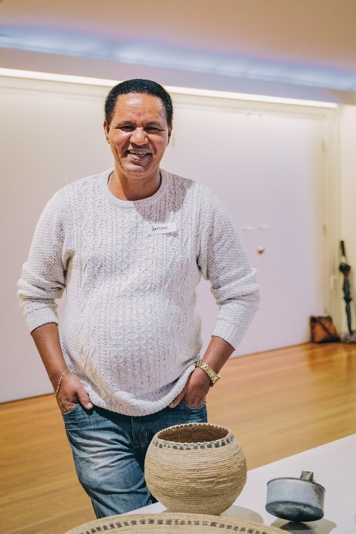 Community Curator Goitom Hidremichael with Eritrean objects donated to the museum through the Community Curator project