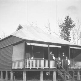 Julius Andersen and his wife standing on the verandah of their house 'Myuna', 28 May 1922