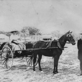 Captain Colvin with two women and a child, c. 1900