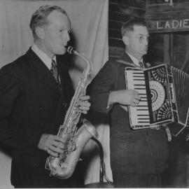 Col Irvine  on saxophone and Col Beavan with accordian performing in Bonville Hall, 1950 