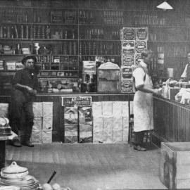 Interior of Bray's Grocery Store with staff and customer, 1914 