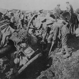 Australian soldiers trying to move artillery mired in mud, 1917