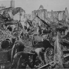 Australian troops clearing a path through a destroyed village, 1917