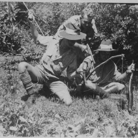 Three soldiers with various weapons, 25 December 1942 