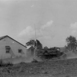 A truck passes a house in Sawtell, c. 1940