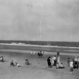 Spectators watching surf lifesavers competing on Sawtell Beach, c.1940