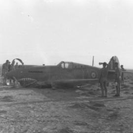 Crewmen surround a crashed Curtis P40 Tomahawk fighter, 1941