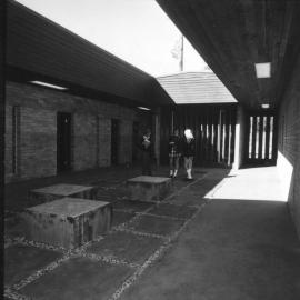 Three students standing in a courtyard at Orara High School, 1972