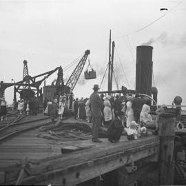 Passengers disembarking in the basket at Coffs Jetty, 19 November 1922