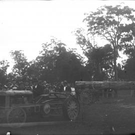 A crowd surrounds a log hauling demonstration, 1912