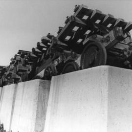 Tipping wagons on the concrete blocks used to build the breakwater, 1970