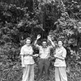 Two Australian nurses hold up Leonard Black, c.1944
