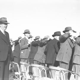 A group of men watch the races at the Coffs Harbour Racing Club's inaugural meeting, 7 August 1948