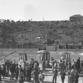 Bookies' pit and the outside crowd on the hill at the Coffs Harbour Racing Club's inaugural meet, 7 August 1948
