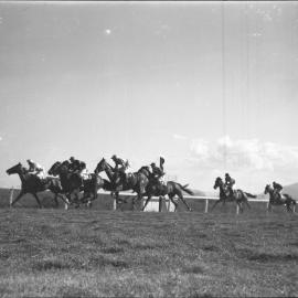 Horses passing the winning post at the Coffs Harbour Racing Club's inaugural meeting, 7 August 1948