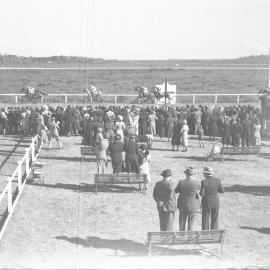 Crowd watch the horses go past the winning post at the Coffs Harbour Racing Club's inaugural meeting, 7 August 1948