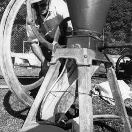 Doug Hoschke demonstrates how to use a corn cracker at the Orara Valley Fair, 10 June 1992 