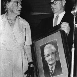 Lottie Vost receives a portrait of her late husband Charles on the closure of the School of Arts, 13 October 1961