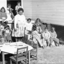 Assisting teacher Shirley Wilson with some children at the Mission, c.1962