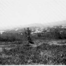 Robert Nicol flying a kite in front of his home at 4 Solitary Street, 1950s 