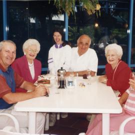 Adelie and Toni "Breakfast on the beach" at Pelican Beach with Bernie and Patricia Malouf, c. 1994