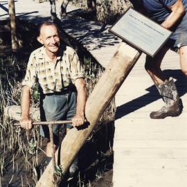 Erecting signs in the mangrove section of the North Coast Regional Botanic Garden