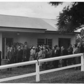 Dr Hewitt plants a tree to open the Country Women's Association at Bellingen