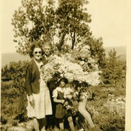 Mum, Connie, Pam and Eva holding Christmas bells, c.1940