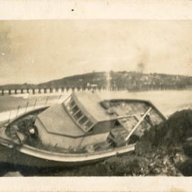 Local fisherman Syd Hardy's boat on rocks at Jetty Beach, 24 June 1950