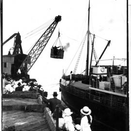 Passengers await transfer by crane and basket onto passenger ship S. S. Orara at the Coffs Harbour Jetty, early 1900s