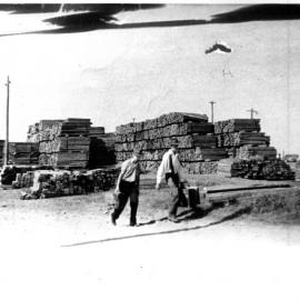 Timber stacked and ready for shipment at Coffs Harbour Jetty, early 1900s 