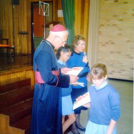 Father Casey presenting certificates to students at St Augustine's Convent School, 1990s 