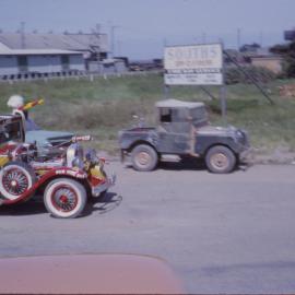 Decorated vintage car in street parade, Coffs Jetty, 1964