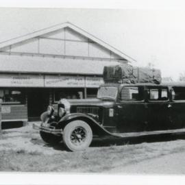 Touring coach outside the smallgoods shop of R.A. Waterhouse, mid 1930s
