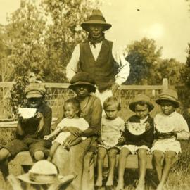 Skinner Family eating watermelon, Red Rock, 1924