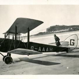 Two men with aeroplane at the beach, 4 June 1930