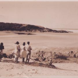 Frank Howe and family observing the rushing outflow at the mouth of Bonville Creek, June 1950  