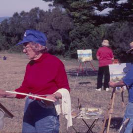 Three women painting 'en plein air' by the beach