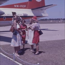 Women standing next to Ansett Fokker F-27 Friendship aeroplane, Coffs Harbour Airport