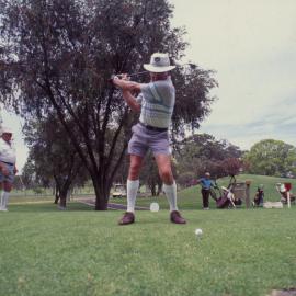 Golfer mid-swing