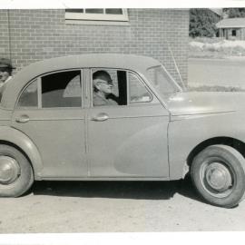 A Morris Minor with three men, c. 1950s