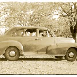 Marie Hunt in Chevy with two passengers, c. 1950s