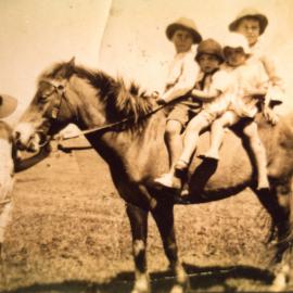 Four children on a pony and one lead
