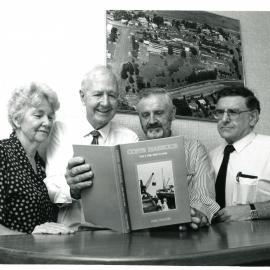 Neil Yeates signs a copy of his Coffs Harbour history, 1990
