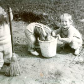 Laura, Ruth and Nancy play with bucket and broom