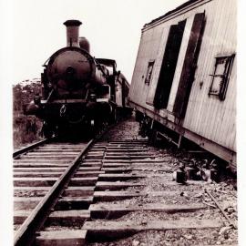 A passenger train eases by the derailment, 1924